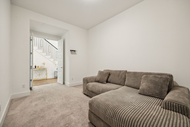 carpeted living room with vaulted ceiling