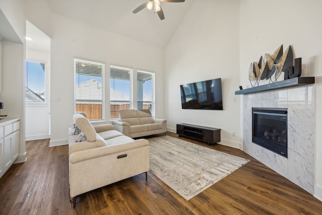 living room with a fireplace, dark hardwood / wood-style floors, high vaulted ceiling, and ceiling fan