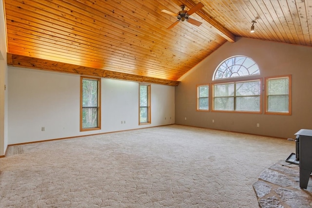 carpeted empty room with ceiling fan, lofted ceiling with beams, and wood ceiling