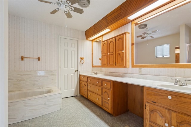 bathroom with vanity, a tub, and ceiling fan