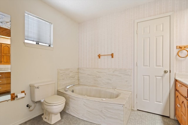 bathroom featuring vanity, tile patterned floors, toilet, and a washtub