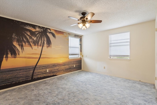 carpeted empty room with wood walls, a textured ceiling, and ceiling fan