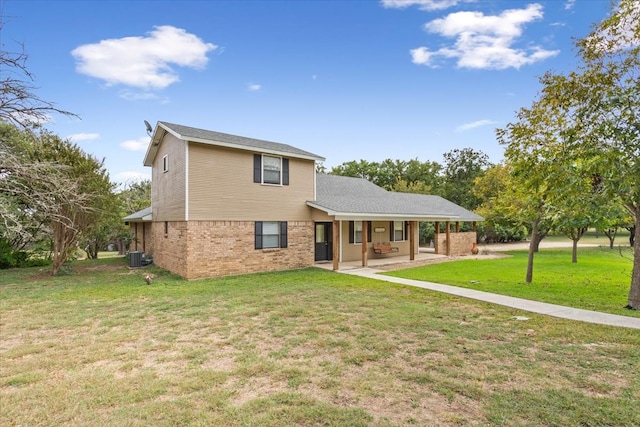 rear view of property featuring a patio area, cooling unit, and a yard