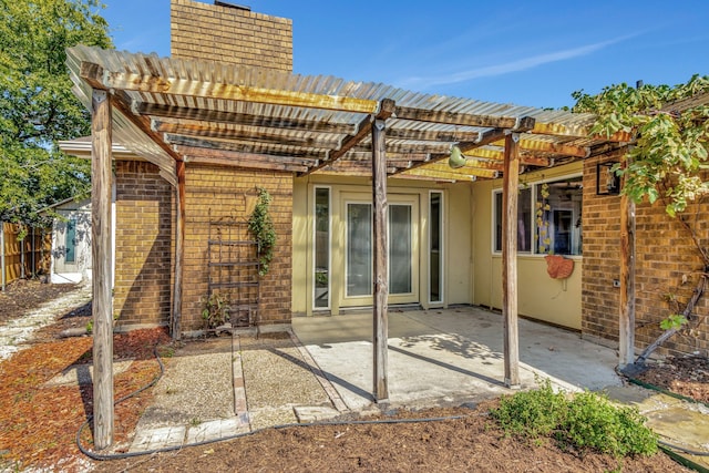 rear view of house featuring a patio and a pergola