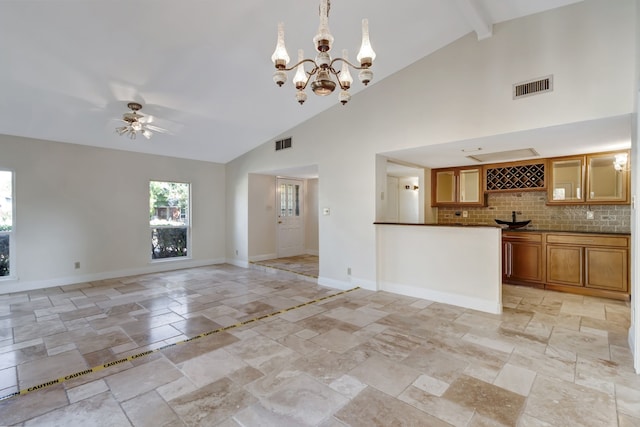 unfurnished living room with high vaulted ceiling, beamed ceiling, and ceiling fan with notable chandelier