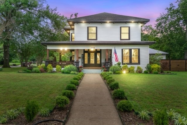 view of front of home featuring a lawn and a porch