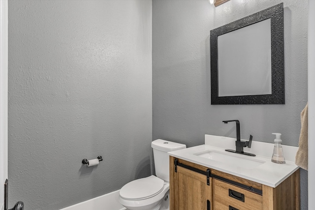 bathroom with toilet and vanity