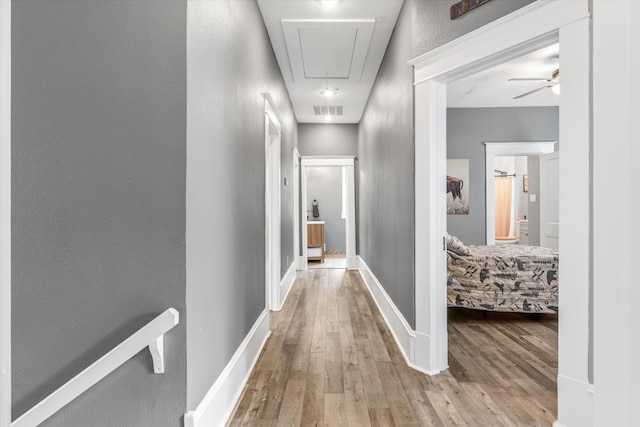 corridor featuring light hardwood / wood-style floors