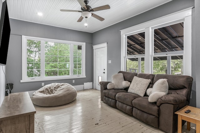 living room with light hardwood / wood-style flooring and ceiling fan