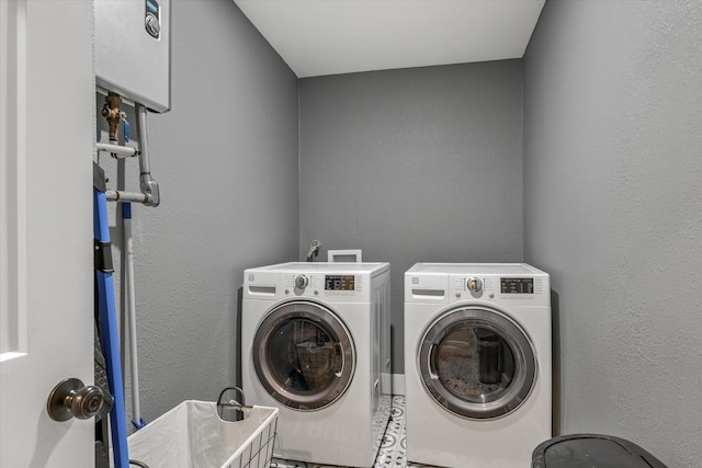 clothes washing area featuring independent washer and dryer