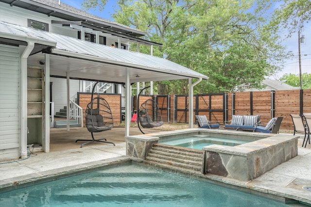 view of pool featuring a patio area and an in ground hot tub