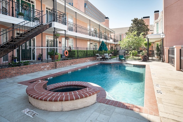 view of pool featuring a patio area and a hot tub