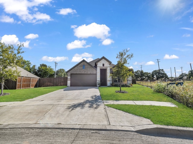 view of front of property with a front lawn and a garage