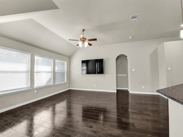 unfurnished living room featuring ceiling fan, vaulted ceiling, and dark hardwood / wood-style floors