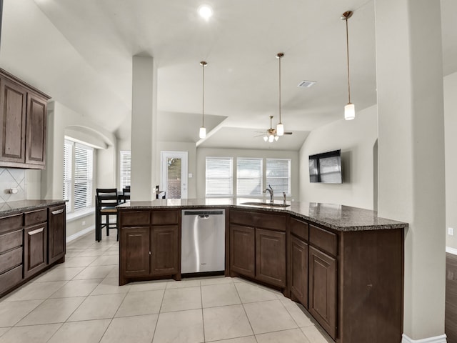 kitchen with dark brown cabinetry, lofted ceiling, and stainless steel dishwasher