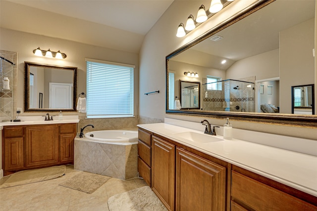 bathroom featuring vanity, lofted ceiling, shower with separate bathtub, and tile patterned flooring