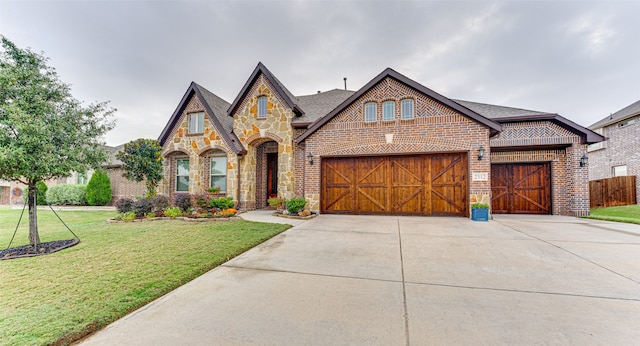 view of front of property with a front yard and a garage