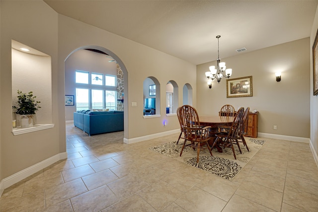 tiled dining room with a notable chandelier