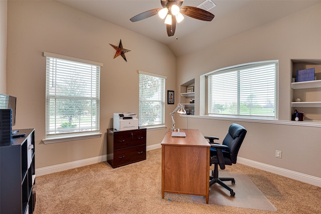 office area featuring ceiling fan, vaulted ceiling, and light colored carpet