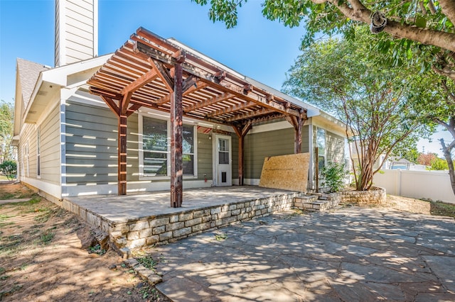 back of property featuring a pergola and a patio area