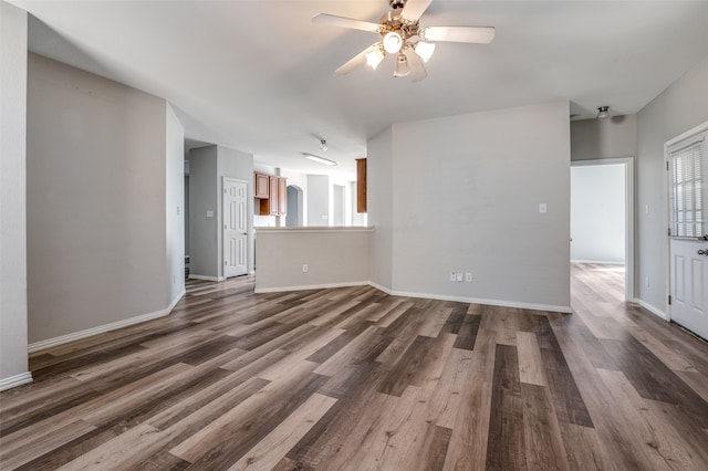 unfurnished living room with dark wood-type flooring and ceiling fan