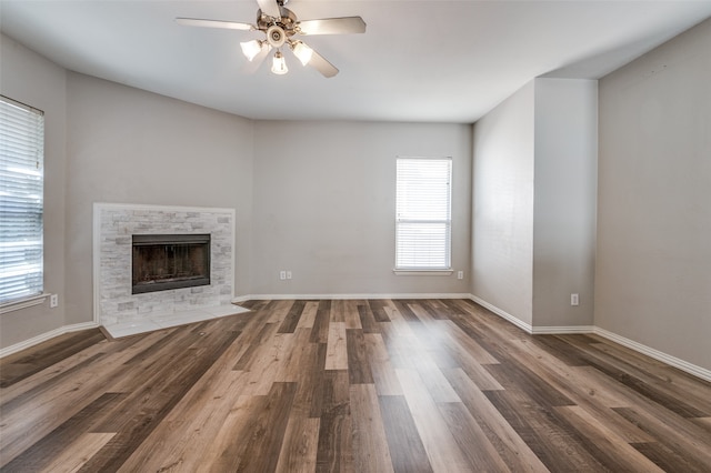 unfurnished living room featuring ceiling fan and dark hardwood / wood-style floors