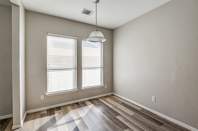 spare room with dark hardwood / wood-style flooring