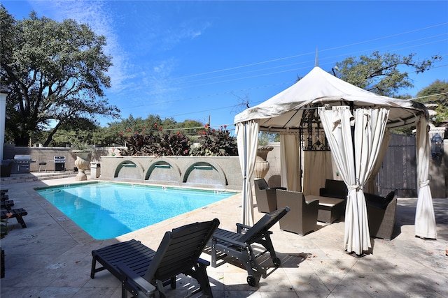 view of swimming pool featuring a gazebo, a patio area, and grilling area