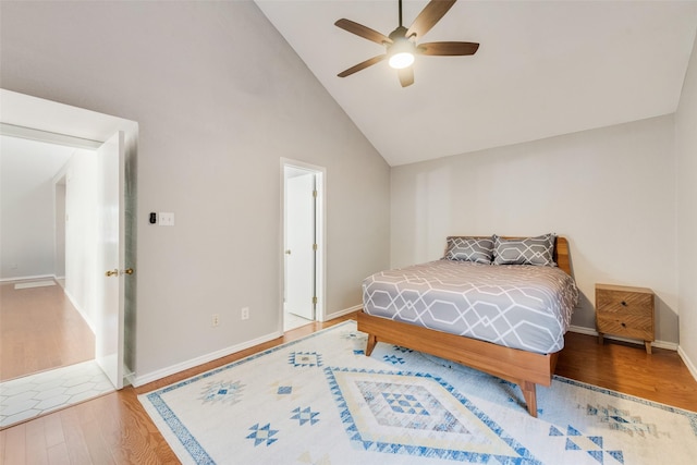 bedroom featuring ceiling fan, wood-type flooring, and high vaulted ceiling