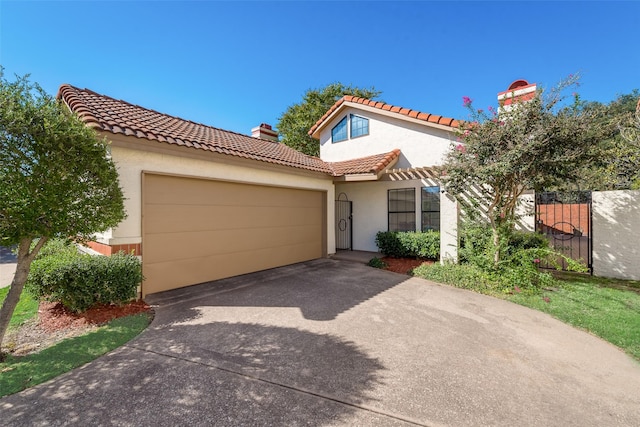 mediterranean / spanish house with a garage