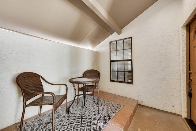 living area with vaulted ceiling with beams