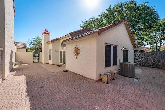 rear view of house with a patio and cooling unit