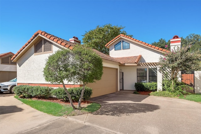 mediterranean / spanish-style home with a garage