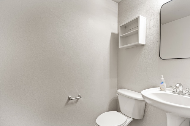 bathroom with toilet and sink