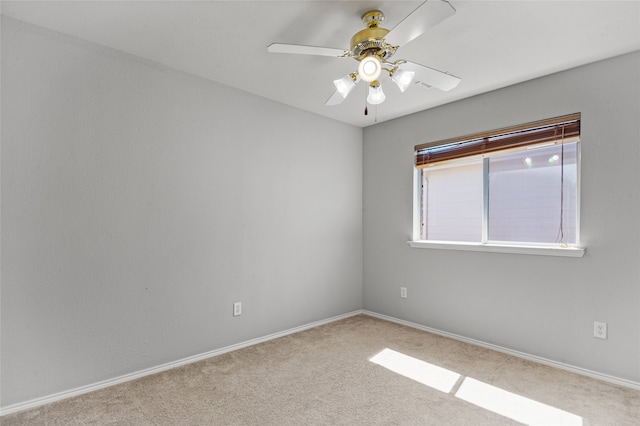 spare room featuring ceiling fan and light colored carpet