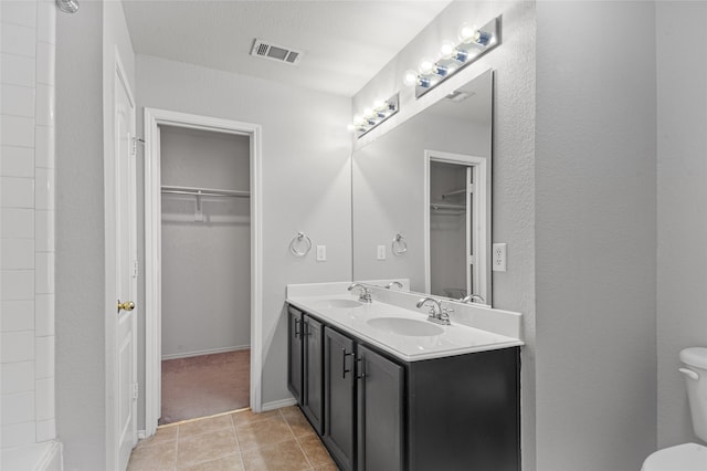 bathroom with vanity, toilet, and tile patterned floors