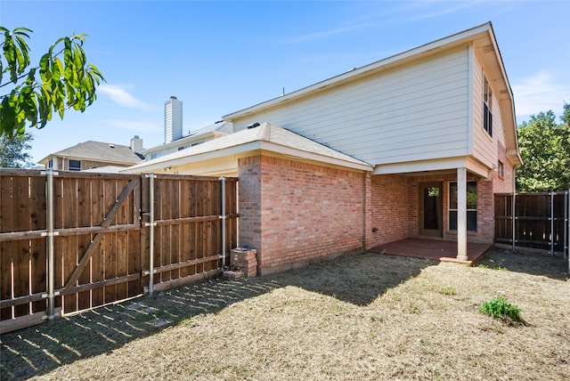 back of house with a lawn