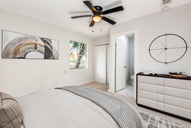 carpeted bedroom featuring ensuite bath and ceiling fan