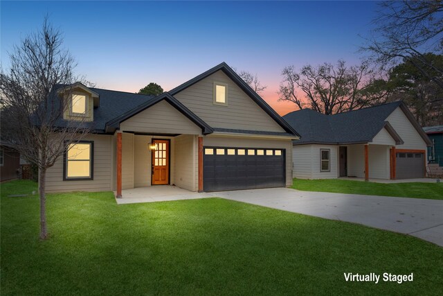 view of front of property with a porch, a garage, and a front yard