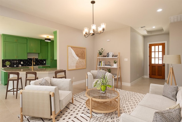 tiled living room with sink and a chandelier