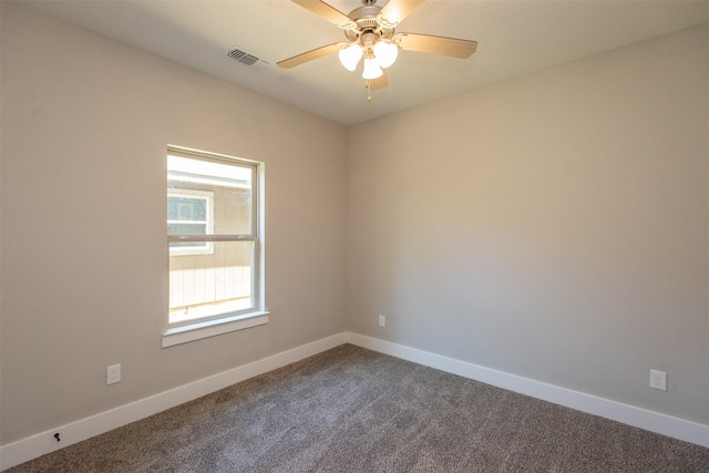 carpeted spare room featuring ceiling fan