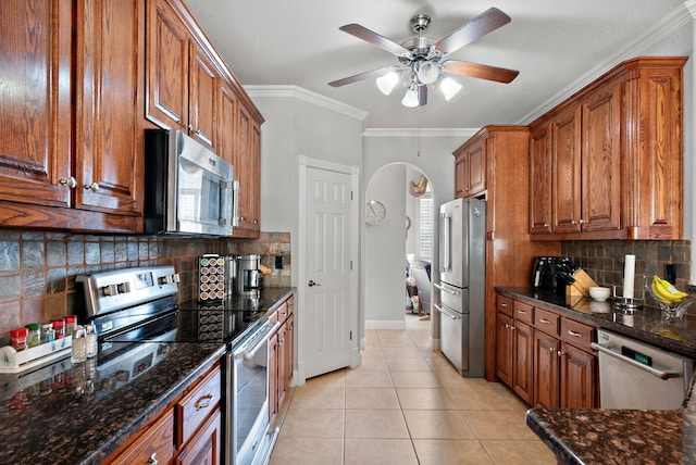 kitchen with crown molding, stainless steel appliances, tasteful backsplash, and plenty of natural light