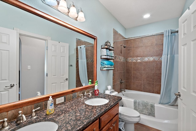 full bathroom featuring vanity, toilet, and shower / tub combo