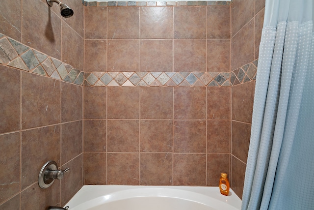 bathroom with shower / bath combo with shower curtain