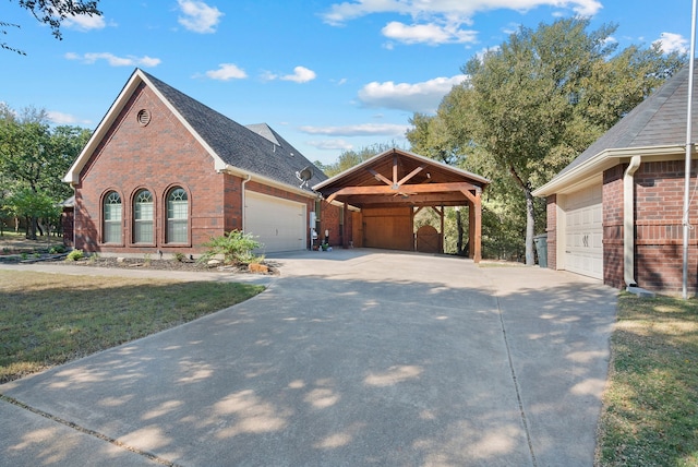 view of front facade featuring a front yard, a garage, and a carport