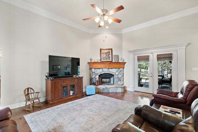 living room with french doors, ornamental molding, dark hardwood / wood-style flooring, a fireplace, and ceiling fan