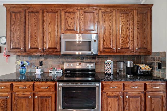 kitchen with tasteful backsplash, appliances with stainless steel finishes, and dark stone counters