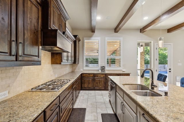 kitchen with sink, decorative backsplash, appliances with stainless steel finishes, beamed ceiling, and light stone counters