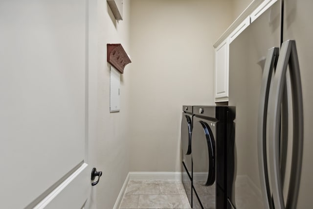 laundry area with cabinets and washing machine and clothes dryer