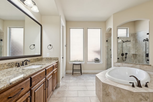 bathroom with vanity, tile patterned floors, and a healthy amount of sunlight